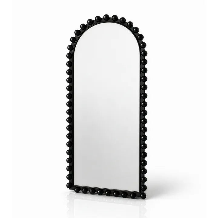 An arched floor mirror with a black beaded frame, shown on a clean white background with a soft reflection underneath.