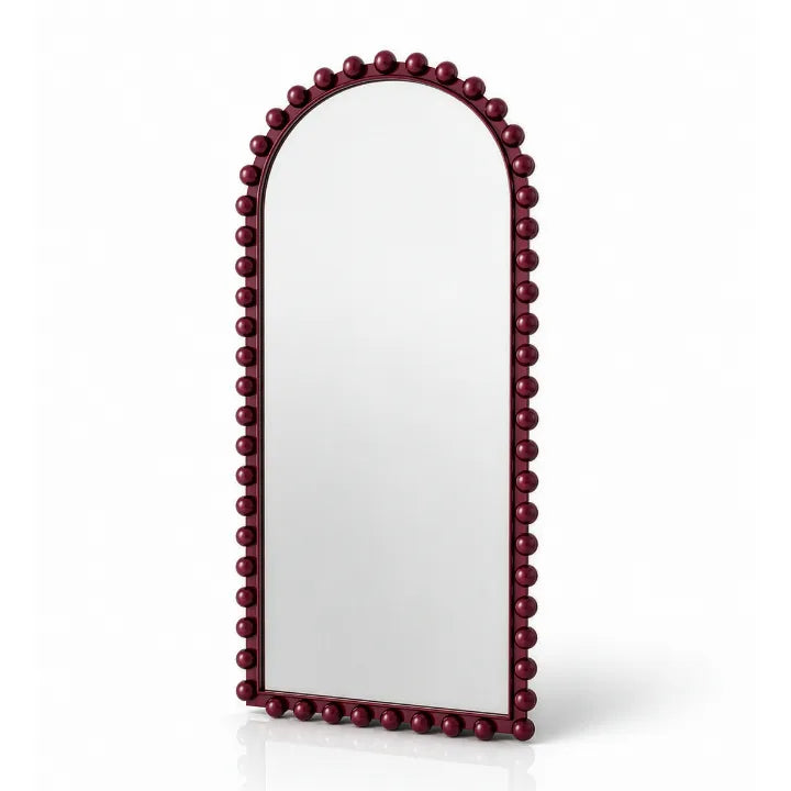 An arched wall mirror with a dark burgundy beaded frame, shown on a clean white background with a soft reflection underneath.